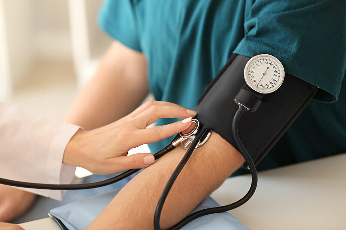 A doctor taking a patients blood pressure