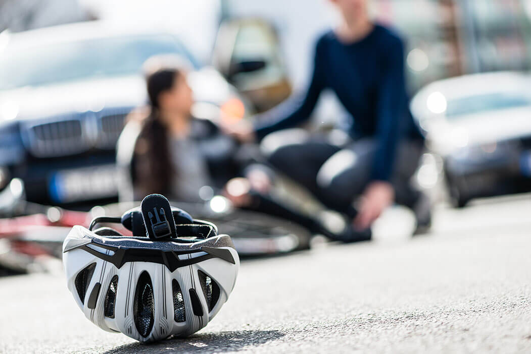 A close up of a bicycle helmet with the cyclist injured in the rear