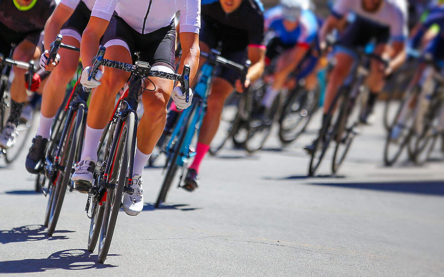 A group of cyclists riding outdoors