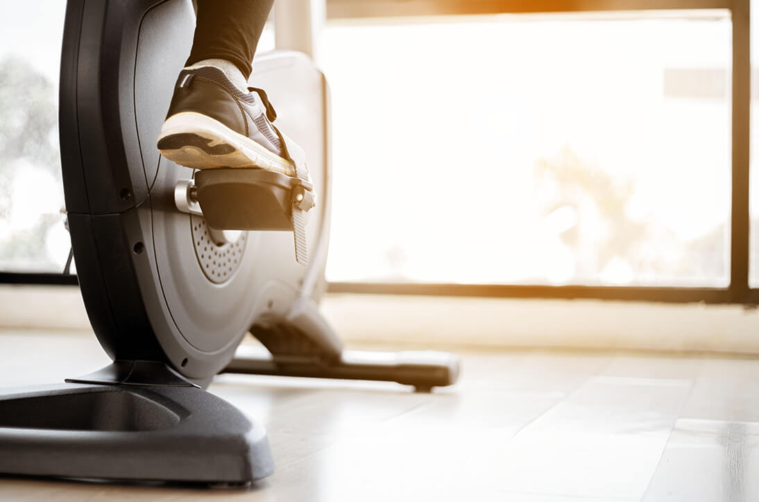 Close up of a cyclists shoes on an indoor bike